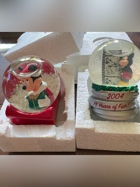 JC Penney Disney 2003 Holiday Sleigh and 2004 75 years of Fun snow globes.